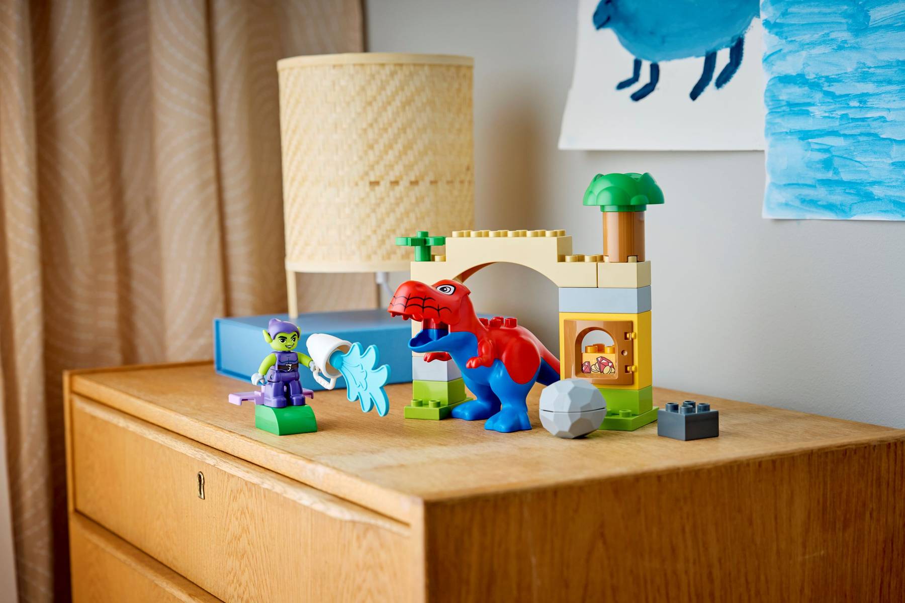 Lego DUPLO 10463 Dinosaur Spidey-Rex and Green Goblin playset featuring colorful dinosaur and superhero figures in a playful scene.
