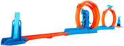 Hot Wheels toy car track set with triple loops and a 1:64 scale vehicle on a colorful track layout.