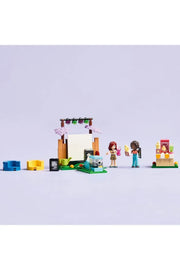 LEGO 42642 Friendship Movie Night set featuring LEGO minifigures and detailed movie-themed accessories on a colorful background.