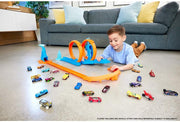 Hot Wheels toy car track set with triple loops and a 1:64 scale vehicle on a colorful track layout.