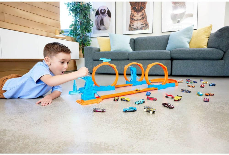 Hot Wheels toy car track set with triple loop and a 1:64 scale vehicle for racing fun and stunts.