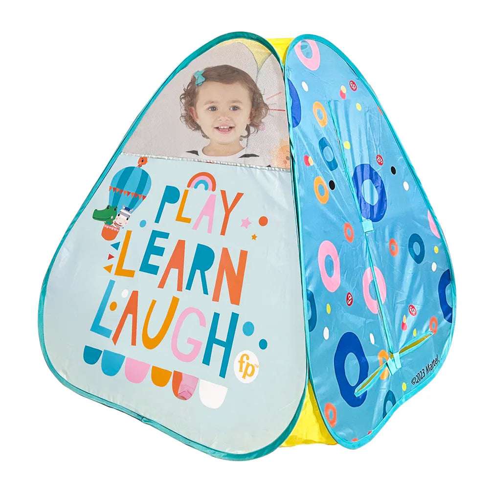 Fisher Price play tent set up on a child's bedroom floor, featuring bright colors and playful design for indoor fun.