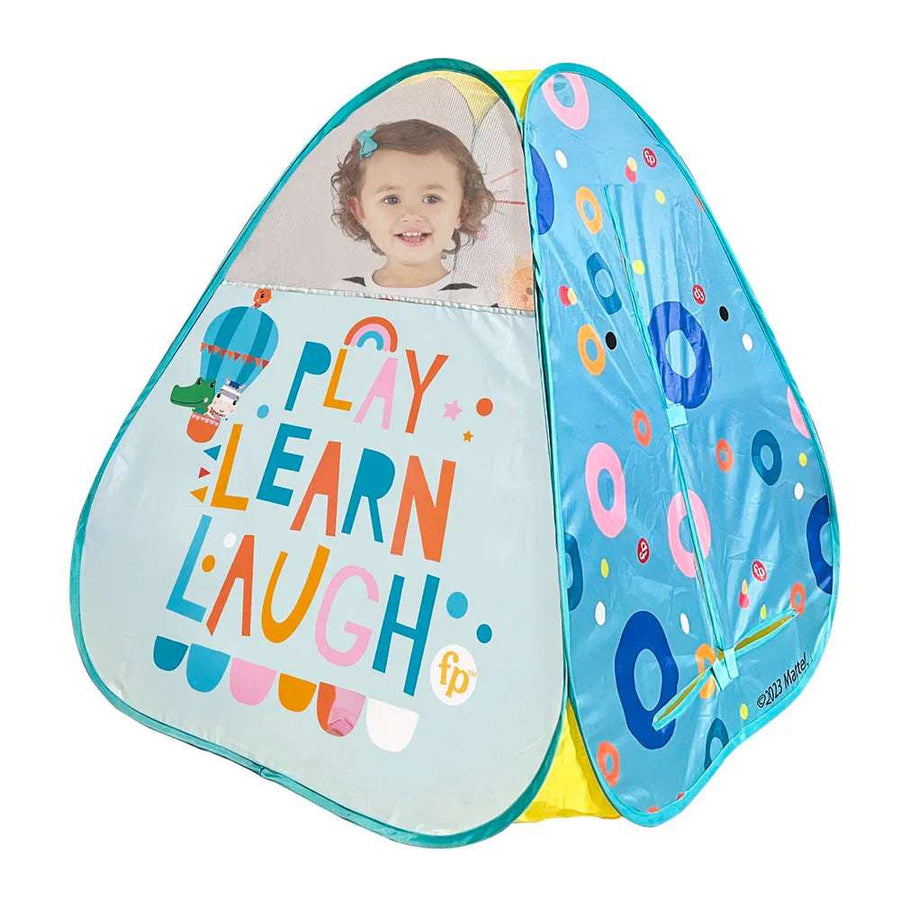 Fisher Price play tent set up on a child's bedroom floor, featuring bright colors and playful design for indoor fun.
