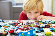 Set of 8 Hot Wheels 1:64 scale basic die-cast cars in various vibrant colors arranged on a surface.