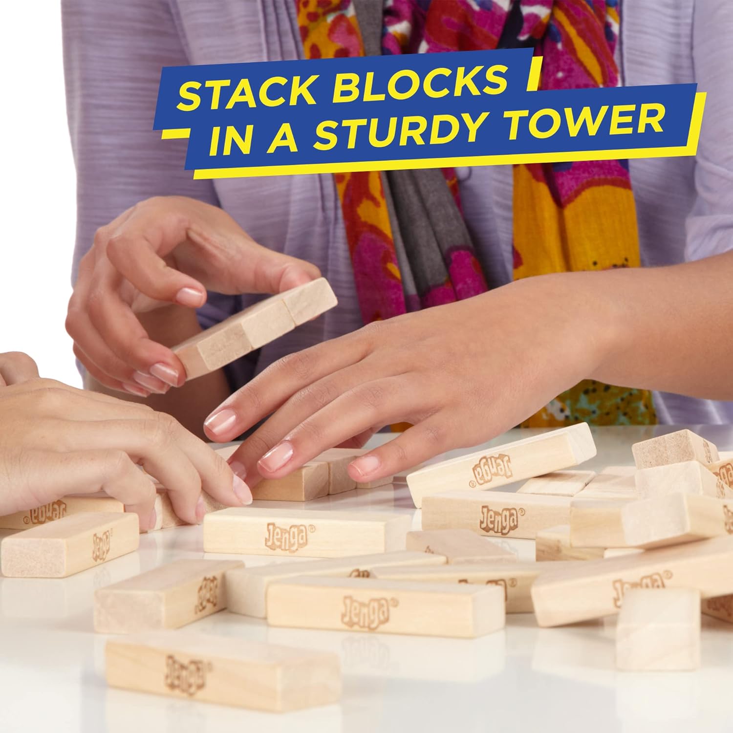 Hasbro Classic Jenga game with wooden blocks stacked in a tower, ready for players to take turns removing and balancing blocks.