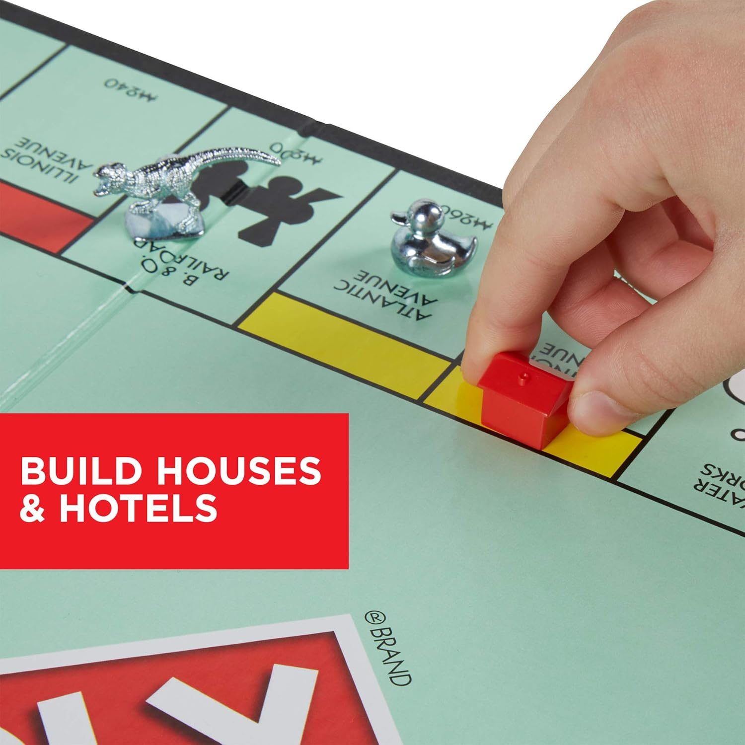 Hasbro Monopoly family board game with colorful game board, playing pieces, and property cards for family fun and entertainment.