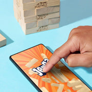 Official Hasbro Jenga game with wooden blocks stacked in a tower for classic skill and balance gameplay.