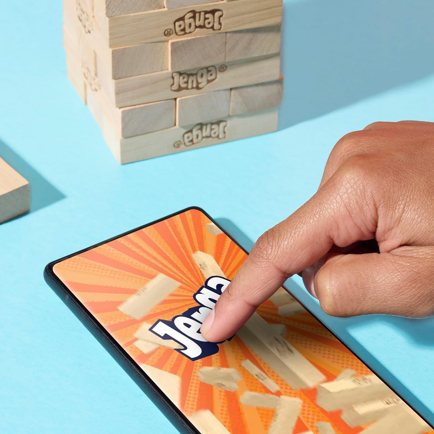 Official Hasbro Jenga game with wooden blocks stacked in a tower, ready for stacking and gameplay.