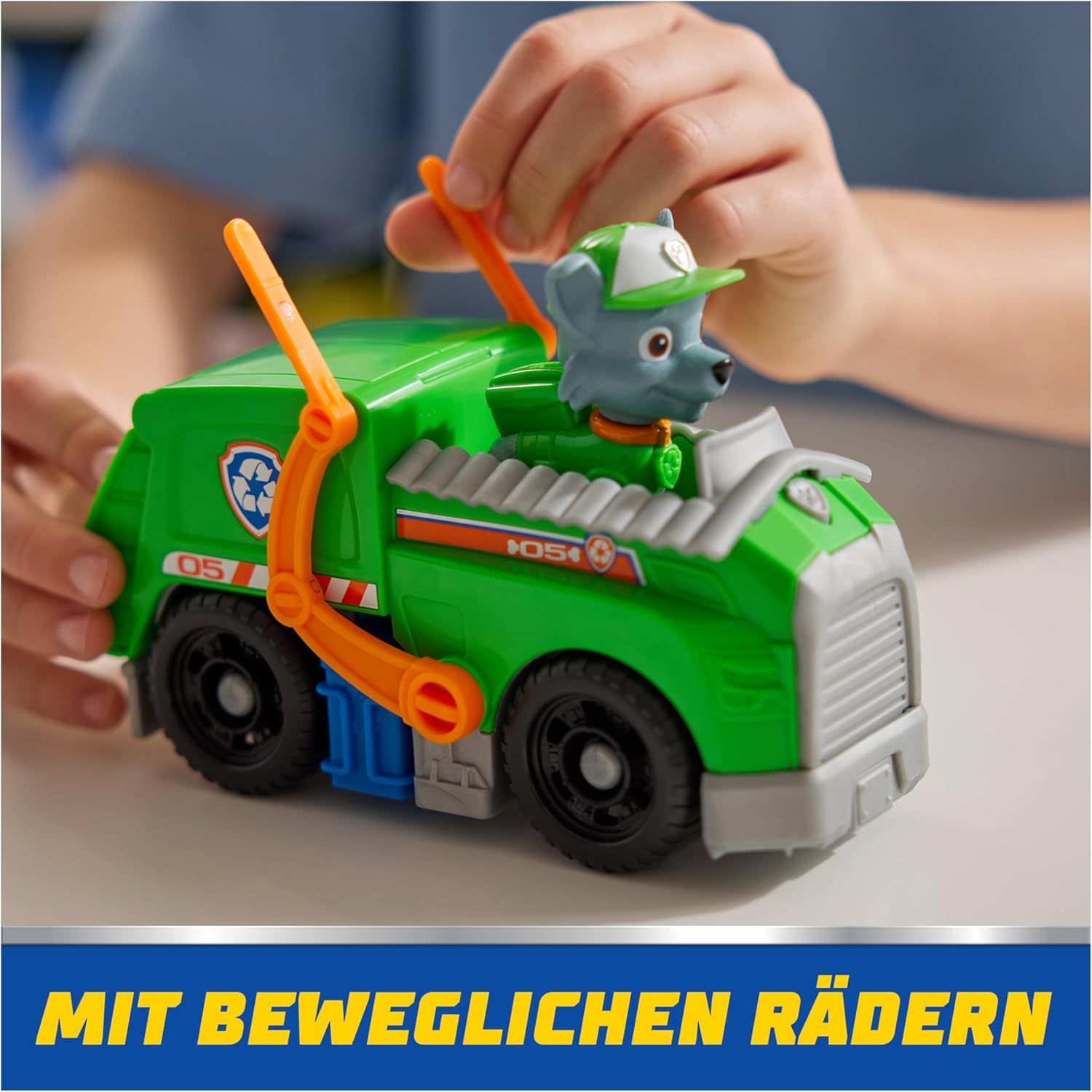 Spin Master PAW Patrol recycling truck with Rocky toy figure, featuring colorful truck design and Rocky figure for imaginative play.