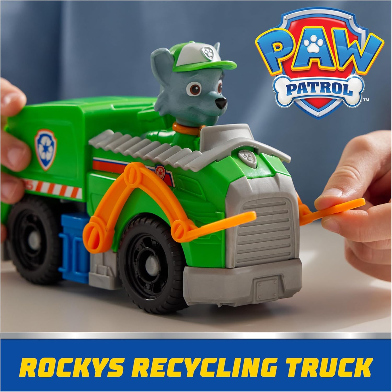 Spin Master PAW Patrol recycling truck toy with Rocky figure, featuring colorful design and realistic truck details.