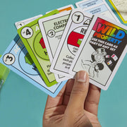 Hasbro Monopoly Deal card game featuring colorful playing cards and game box on a white background.