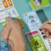 Hasbro Monopoly Deal card game featuring colorful playing cards and game box on a white background.
