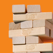 Official Hasbro Jenga game with wooden blocks stacked in a tower for classic skill and balance gameplay.