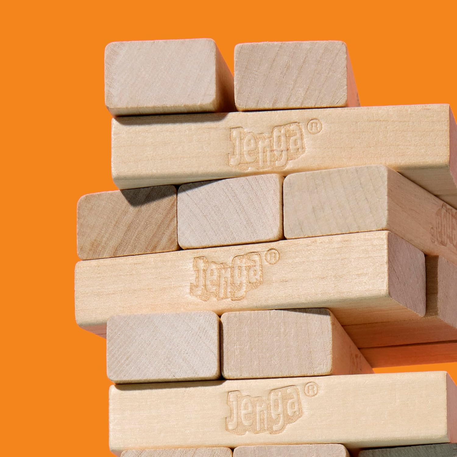 Hasbro Official Jenga game with wooden blocks stacked in a tower for a balancing game.