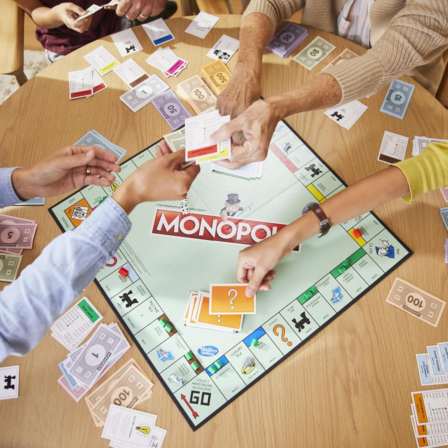 Hasbro Monopoly family board game with colorful game board, playing pieces, and property cards for fun family gameplay