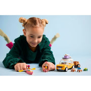 LEGO Friends hip road-trip travel car set 42659 with colorful car, travel accessories, and mini-figures on a scenic background.
