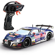 Carrera Red Bull Audi R8 LMS GT3 EVO II remote control toy car on a track, featuring detailed design and vibrant Red Bull and Audi logos.